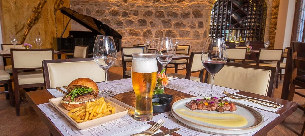 Beautiful table with beer, wine, a hamburger and a porkchop